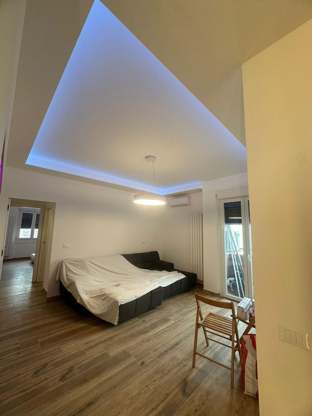 Camera con luce LED a soffitto e parete in legno